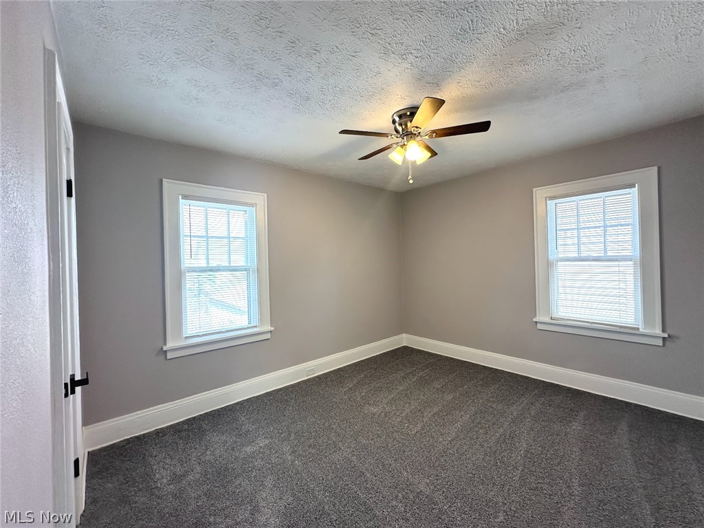3409 Cedarbrook Road Cleveland Heights, OH 44118 - Photo 10 of 16 Spare room featuring dark carpet, a textured ceiling, and ceiling fan