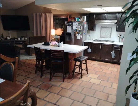 a dining hall with stainless steel appliances a table and chairs