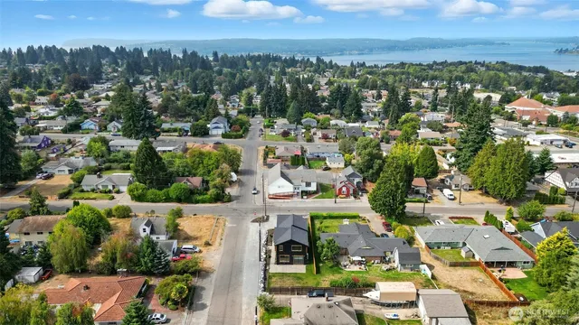 an aerial view of residential houses with outdoor space and street view