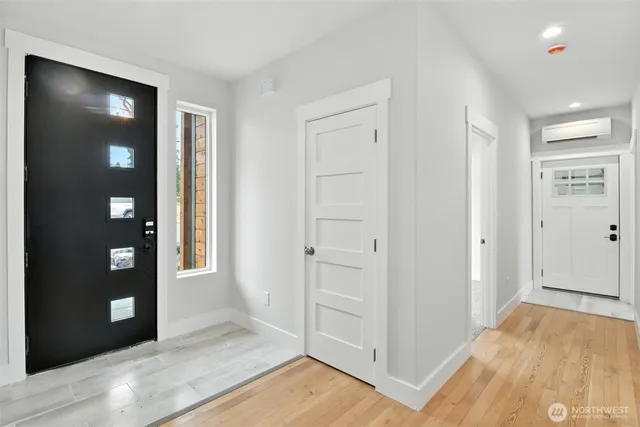 a large kitchen with kitchen island a sink and a wooden floor