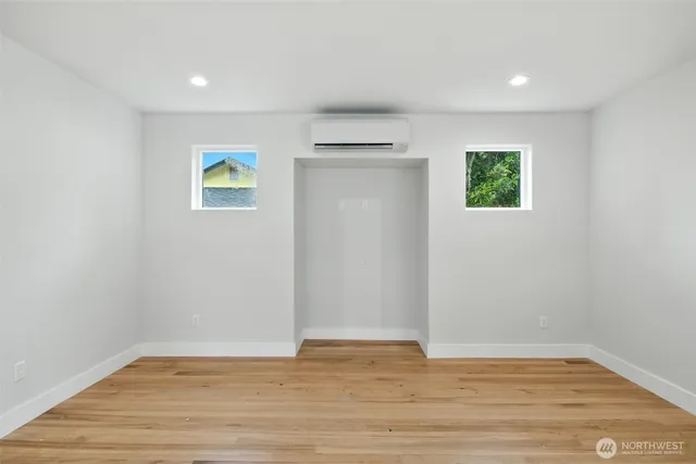 a kitchen that has a lot of cabinets and wooden floor