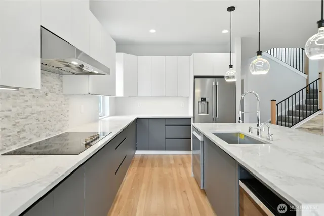 a kitchen with kitchen island a sink stainless steel appliances and cabinets