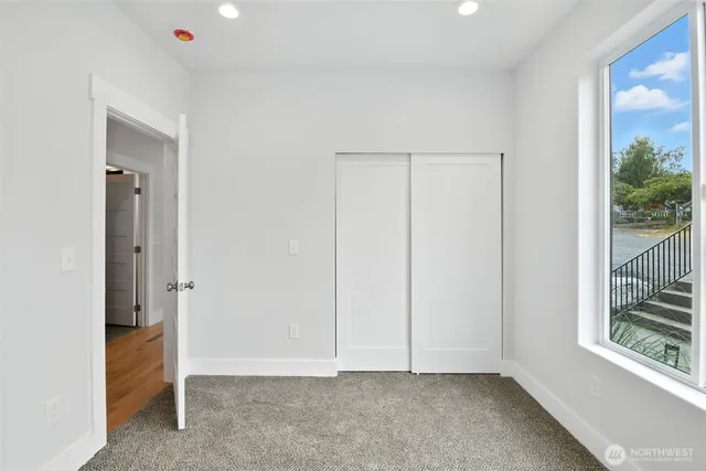 an empty room with wooden floor and a window
