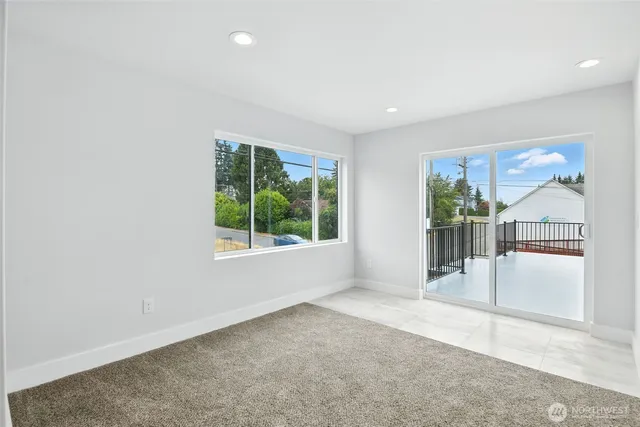 an empty room with windows and outdoor space
