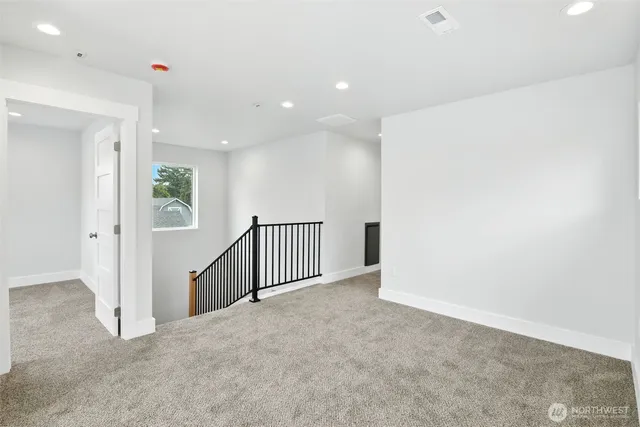 a bathroom with a granite countertop sink toilet and mirror