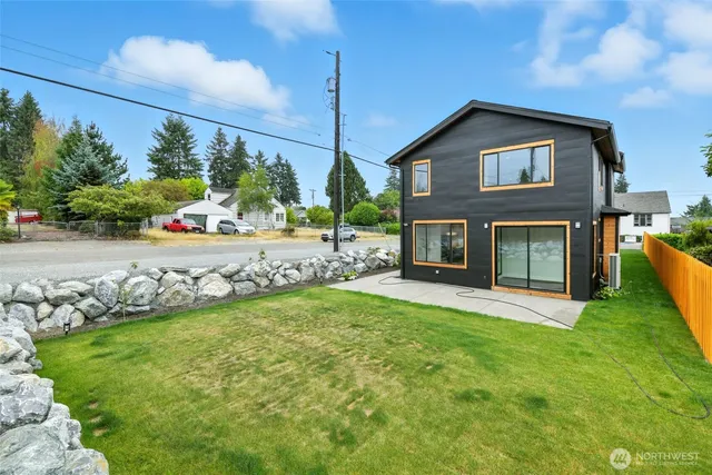 a view of a house with a yard and sitting area