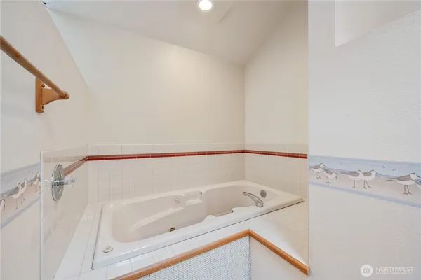 a bathroom with a tub and shower