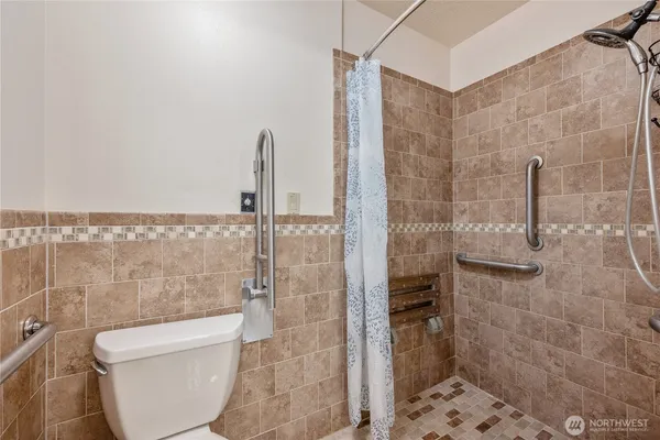 a bathroom with a toilet and a shower