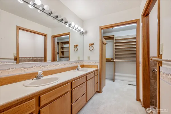 a bathroom with a tub sink and mirror
