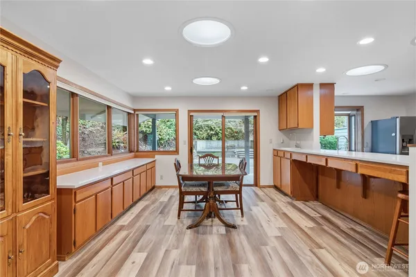 a kitchen with stainless steel appliances granite countertop sink stove and wooden cabinets