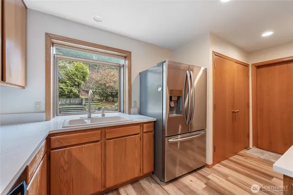 a kitchen with stainless steel appliances granite countertop a refrigerator and a sink