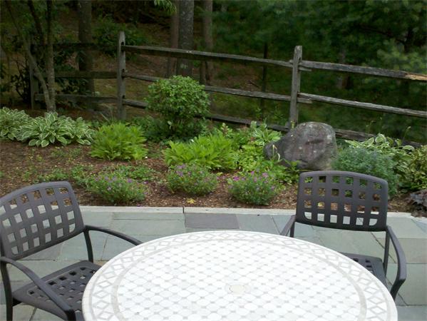 68 Pickwick Way, Unit 68 Wayland, MA 01778 - Photo 14 of 15 a view of a chairs and table in the back yard