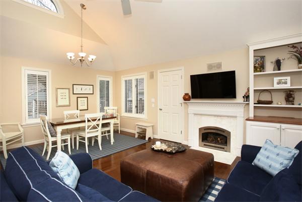 68 Pickwick Way, Unit 68 Wayland, MA 01778 - Photo 2 of 15 a living room with furniture a fireplace and a flat screen tv
