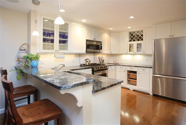 68 Pickwick Way, Unit 68 Wayland, MA 01778 - Photo 3 of 15 a kitchen with a refrigerator a stove a sink and a microwave