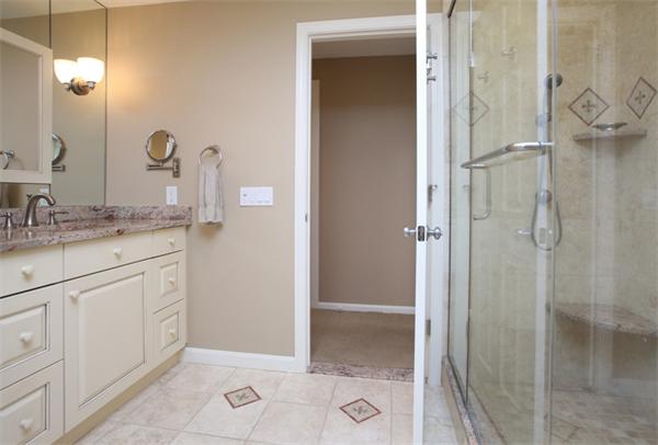68 Pickwick Way, Unit 68 Wayland, MA 01778 - Photo 4 of 15 a bathroom with a granite countertop sink a mirror and shower