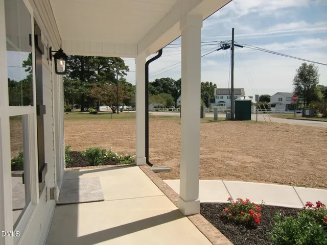 a living room with fireplace furniture and a large window