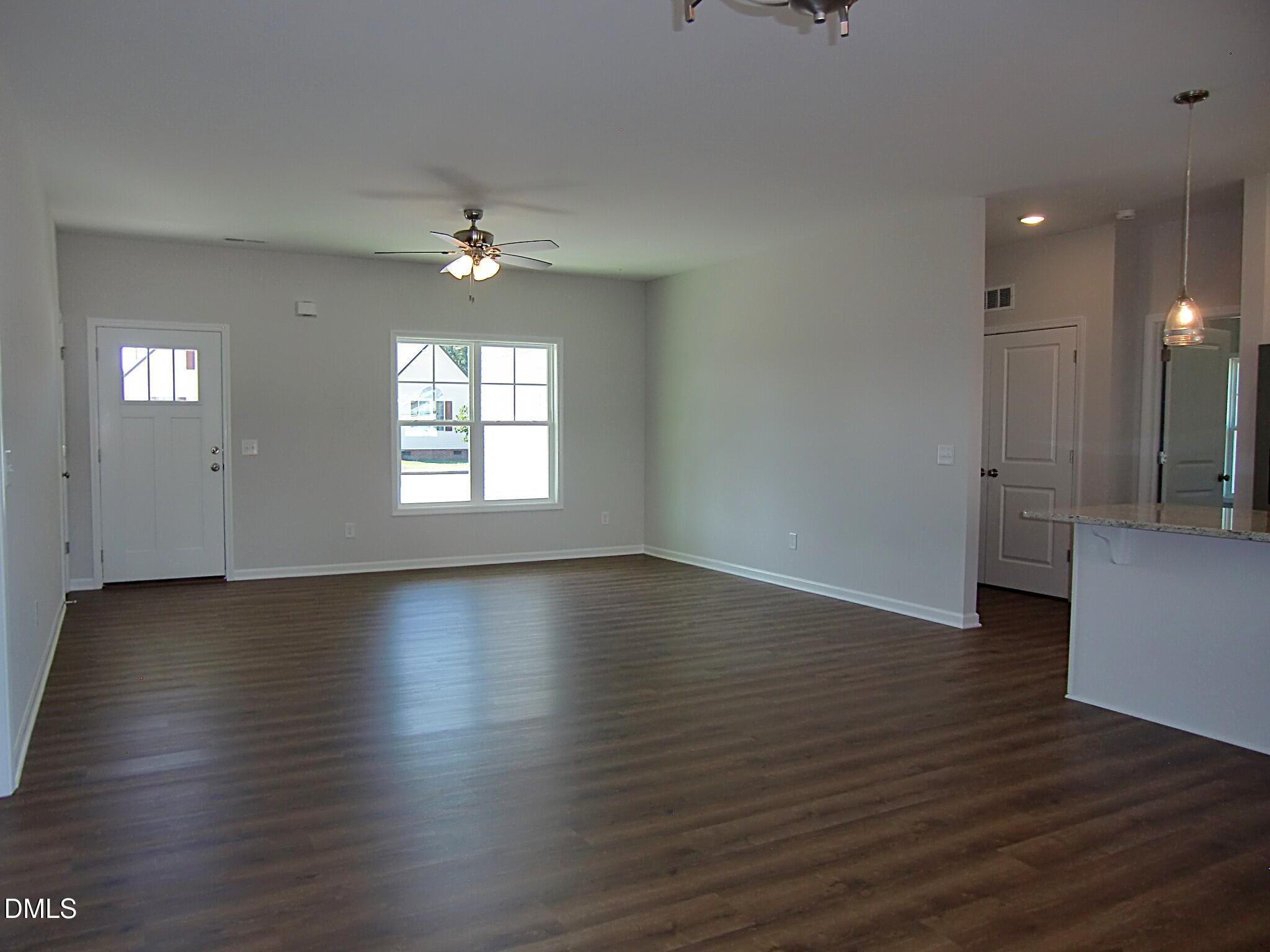 100 Covington Lane Dunn, NC 28334 - Photo 16 of 54 an empty room with wooden floor and windows