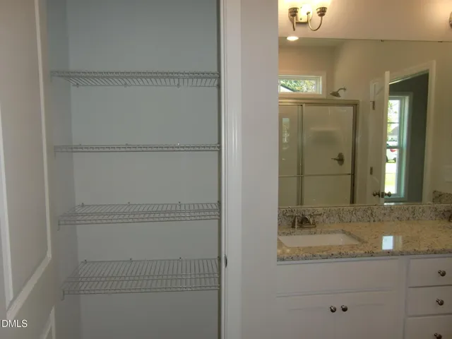 a bathroom with a glass shower door