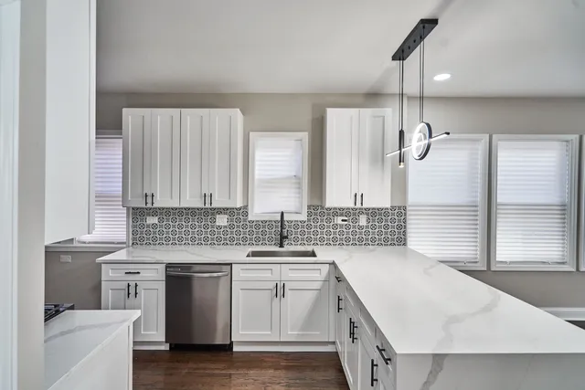 a kitchen with a sink stove and cabinets