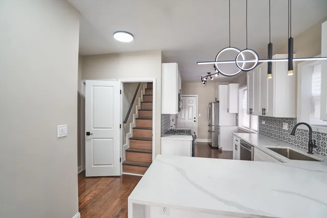 a view of a bathroom with mirror and sink