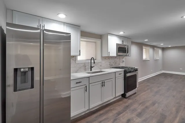 a spacious bathroom with a granite countertop sink mirror and shower