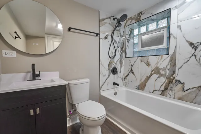 a bathroom with a sink a toilet and a mirror