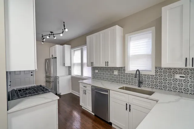 a kitchen with a sink stove and refrigerator