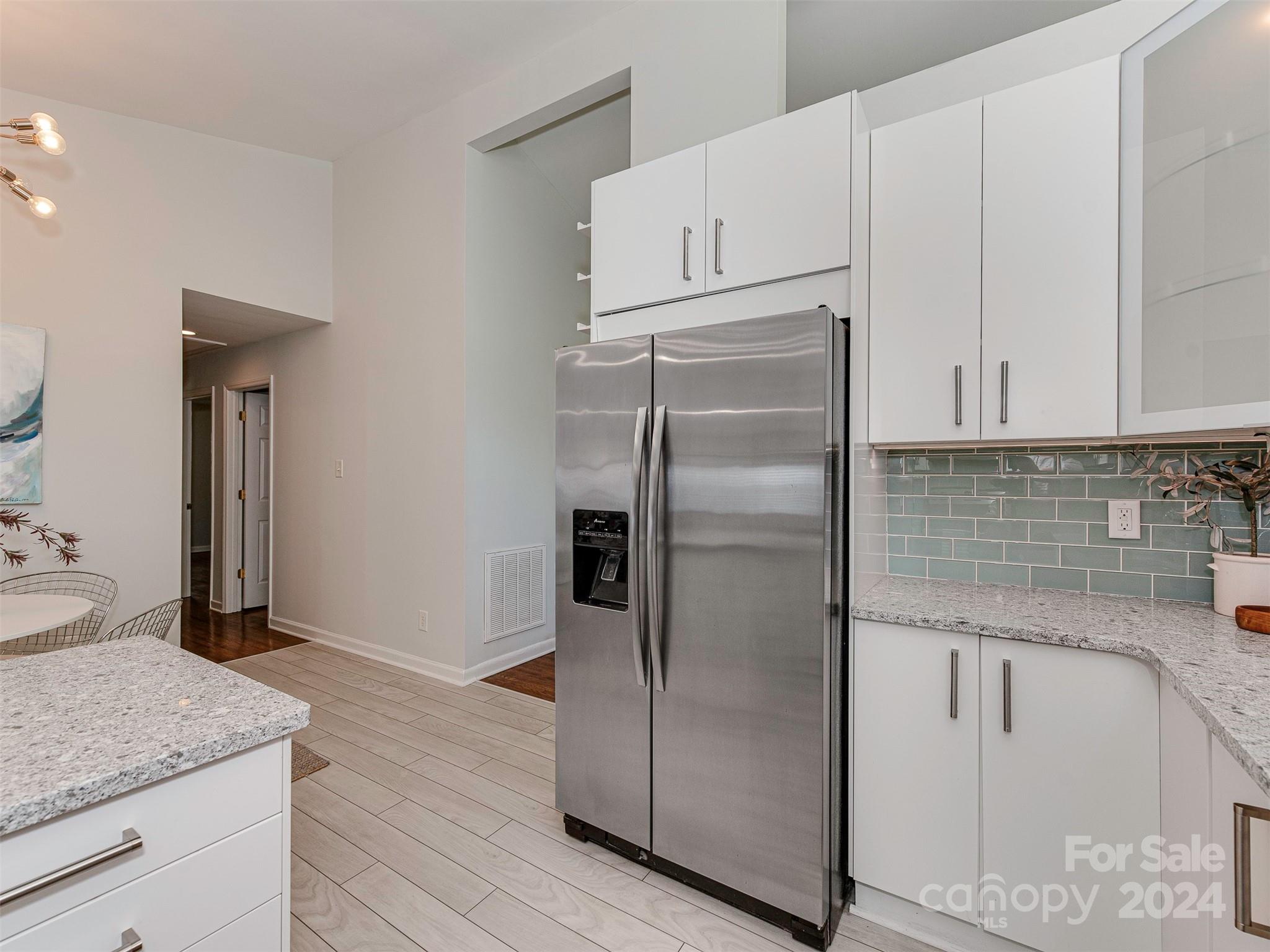 5541 Toano Road Charlotte, NC 28215 - Photo 11 of 35 a kitchen with stainless steel appliances granite countertop a refrigerator a sink and white cabinets