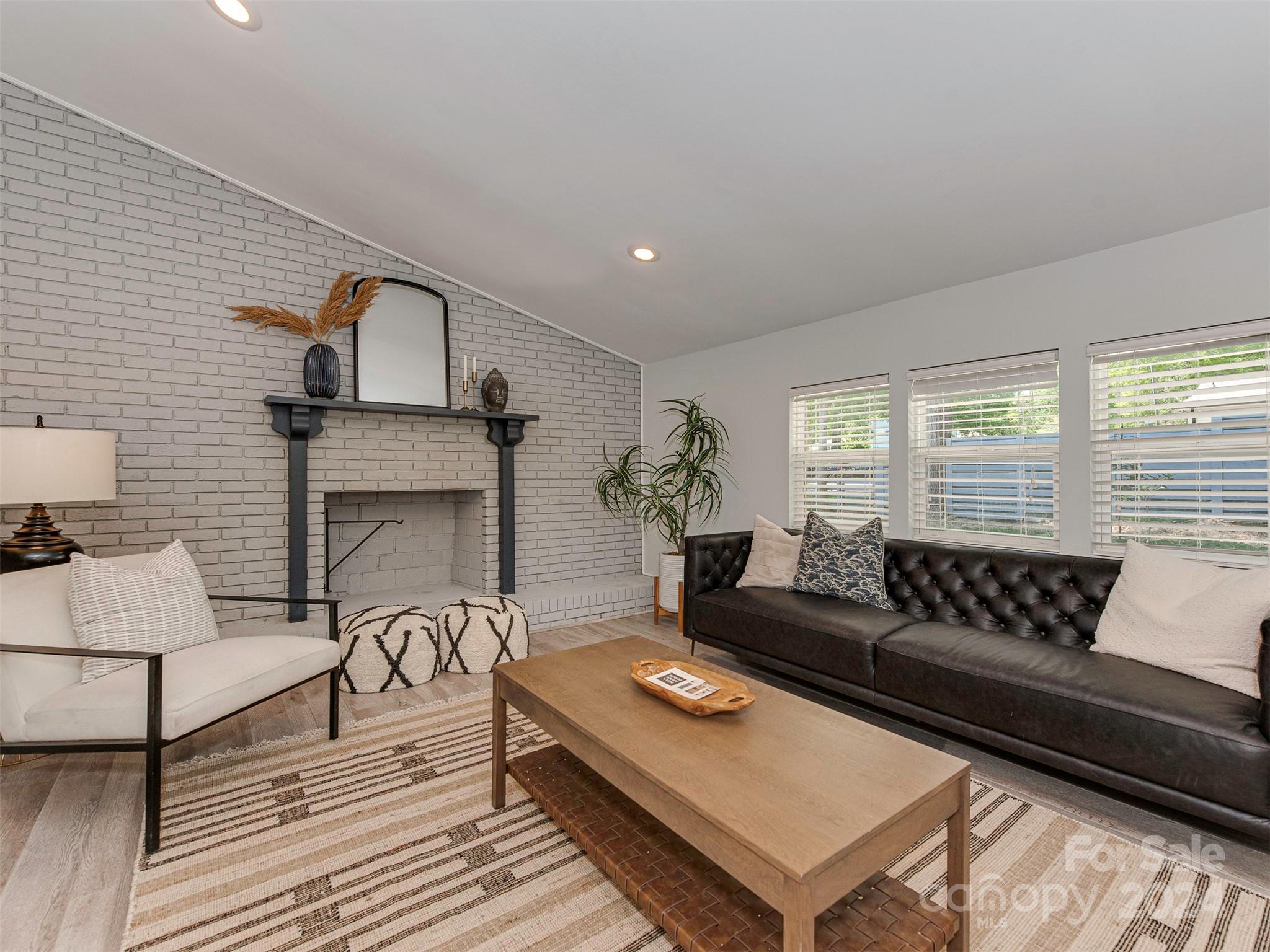 5541 Toano Road Charlotte, NC 28215 - Photo 12 of 35 a living room with furniture and a fireplace