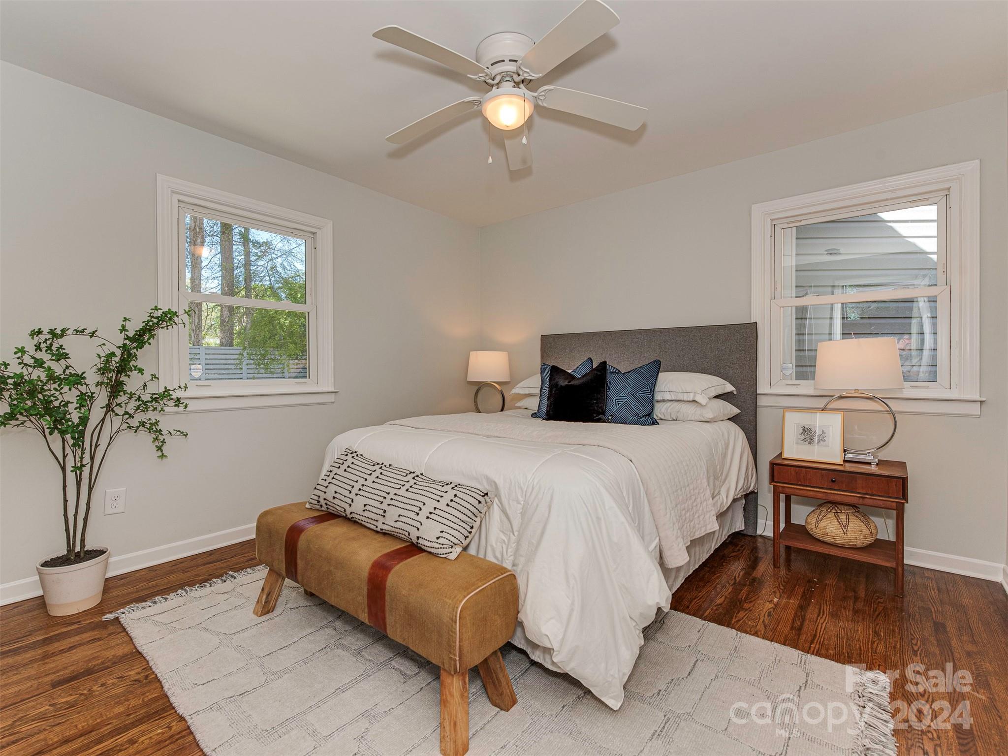 5541 Toano Road Charlotte, NC 28215 - Photo 16 of 35 a bedroom with a bed and a potted plant