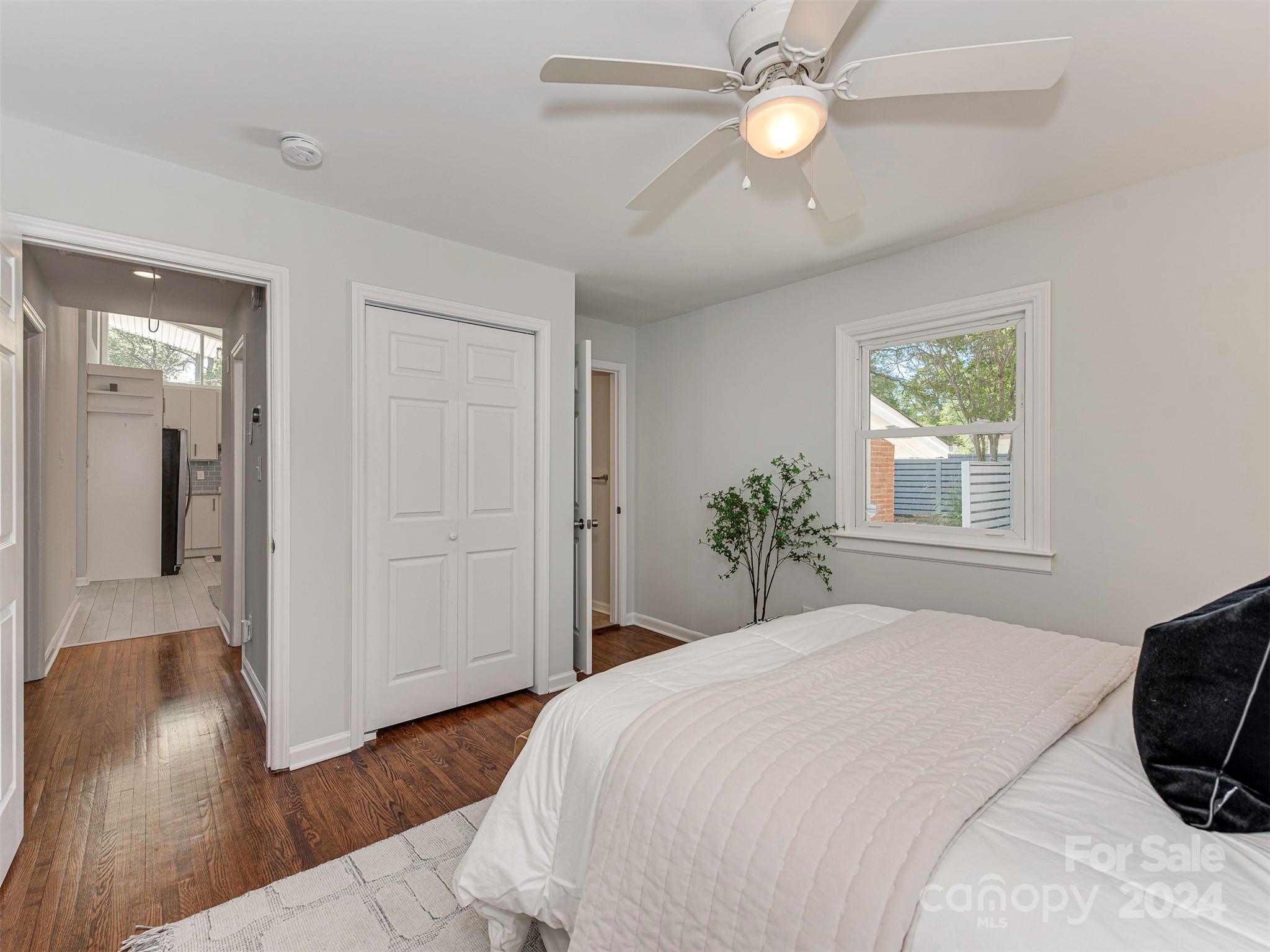 5541 Toano Road Charlotte, NC 28215 - Photo 17 of 35 a bedroom with a bed and a chandelier
