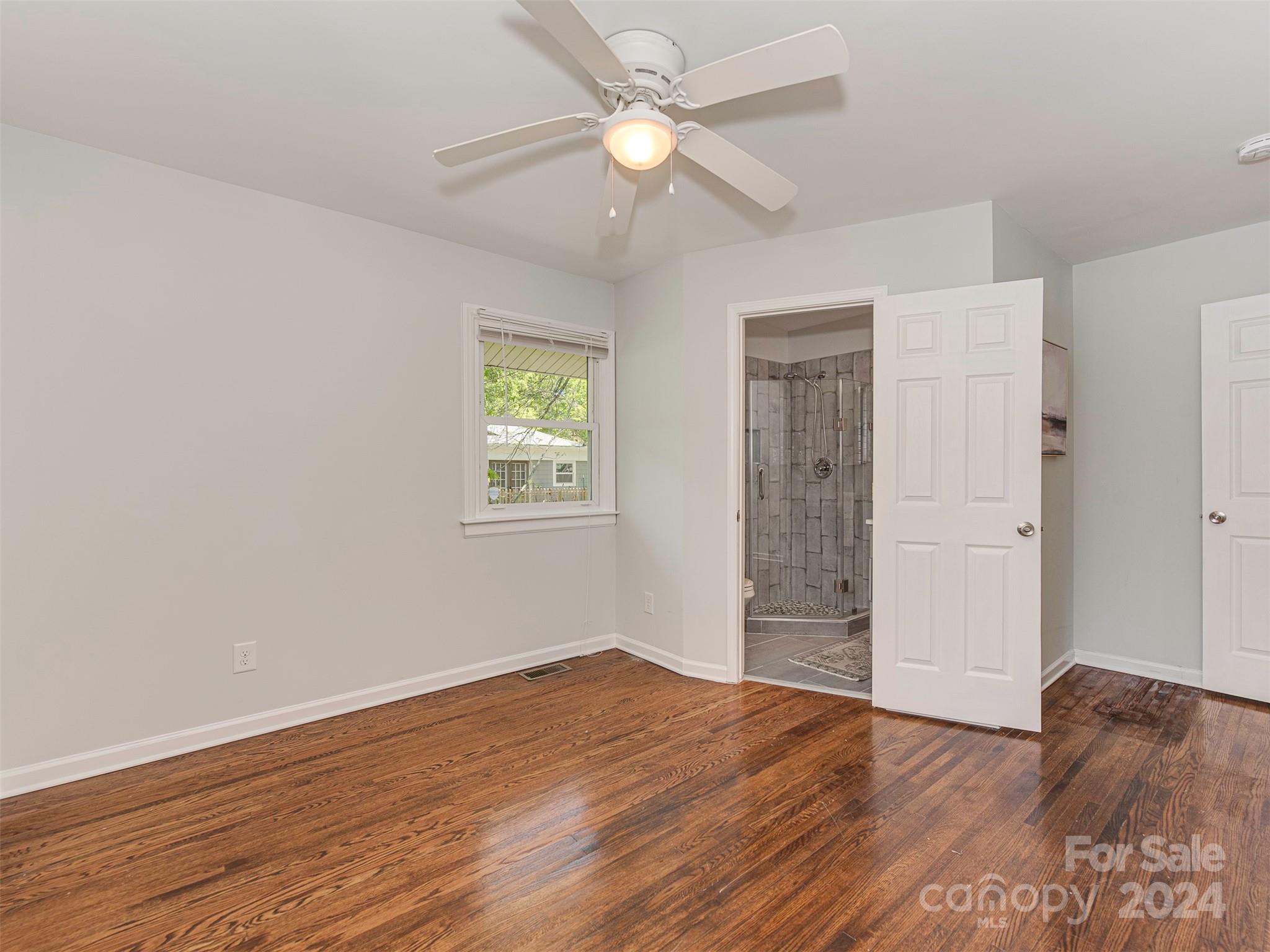 5541 Toano Road Charlotte, NC 28215 - Photo 21 of 35 a view of empty room with wooden floor and fan