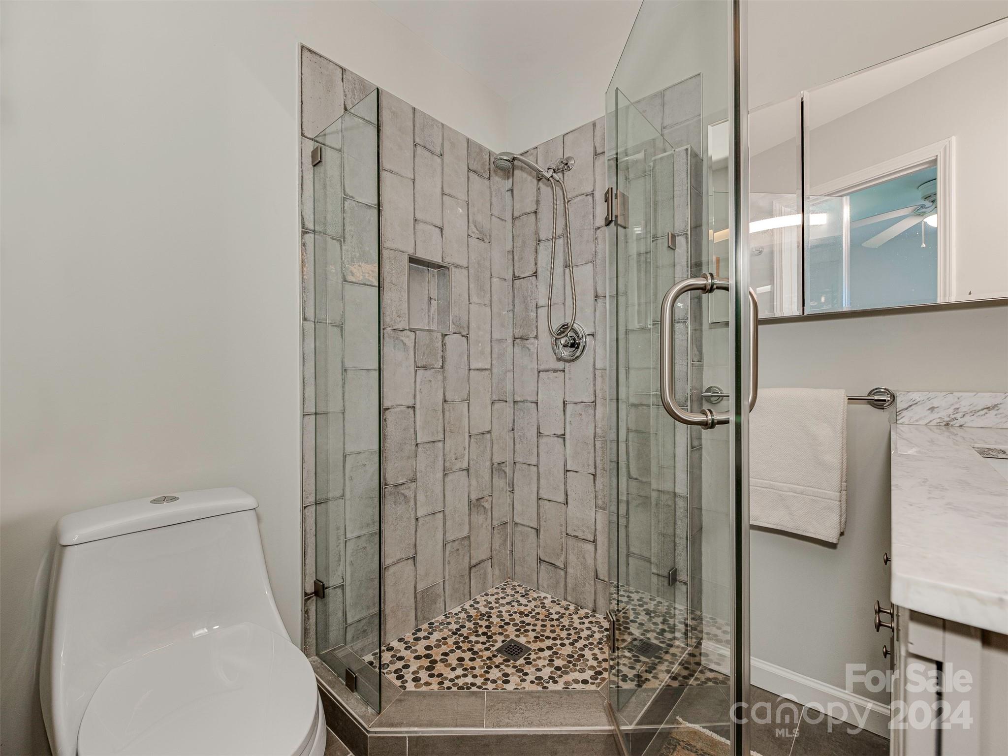 5541 Toano Road Charlotte, NC 28215 - Photo 22 of 35 a bathroom with a shower and toilet
