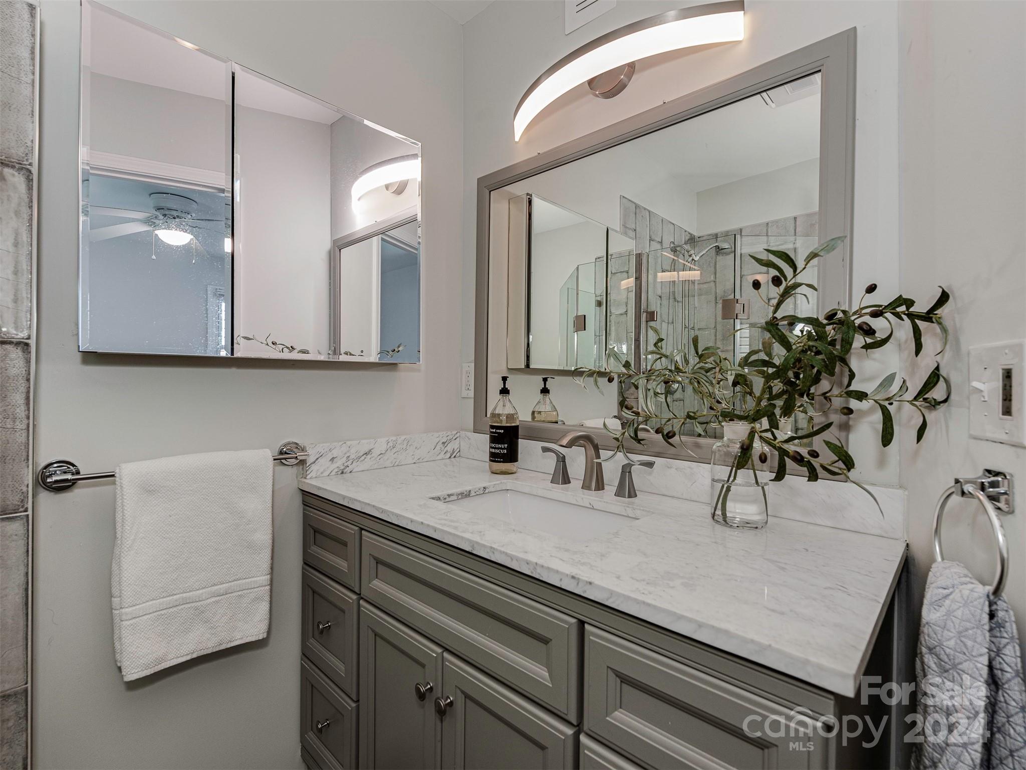 5541 Toano Road Charlotte, NC 28215 - Photo 23 of 35 a bathroom with a sink and a mirror