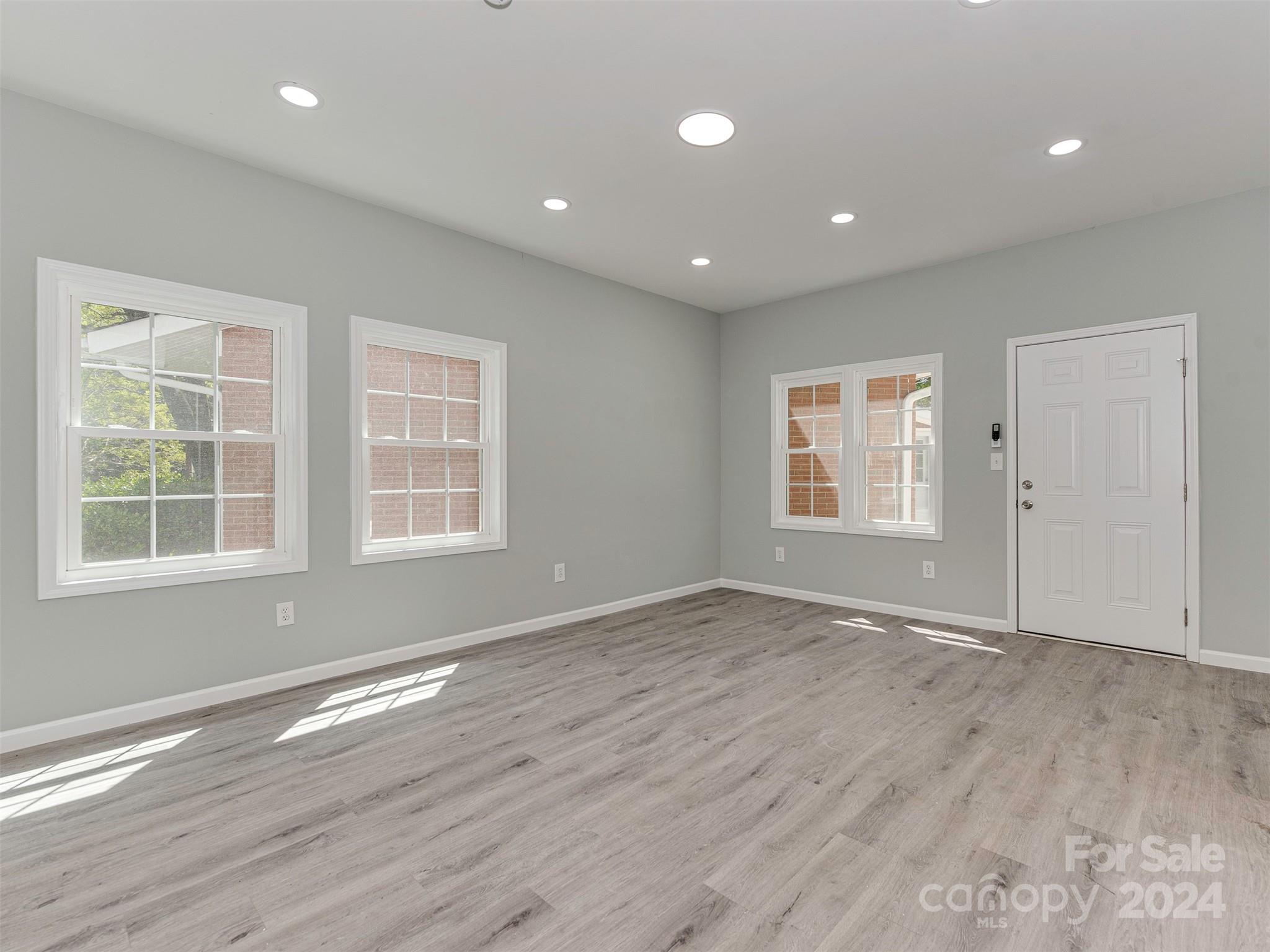 5541 Toano Road Charlotte, NC 28215 - Photo 27 of 35 an empty room with wooden floor and windows