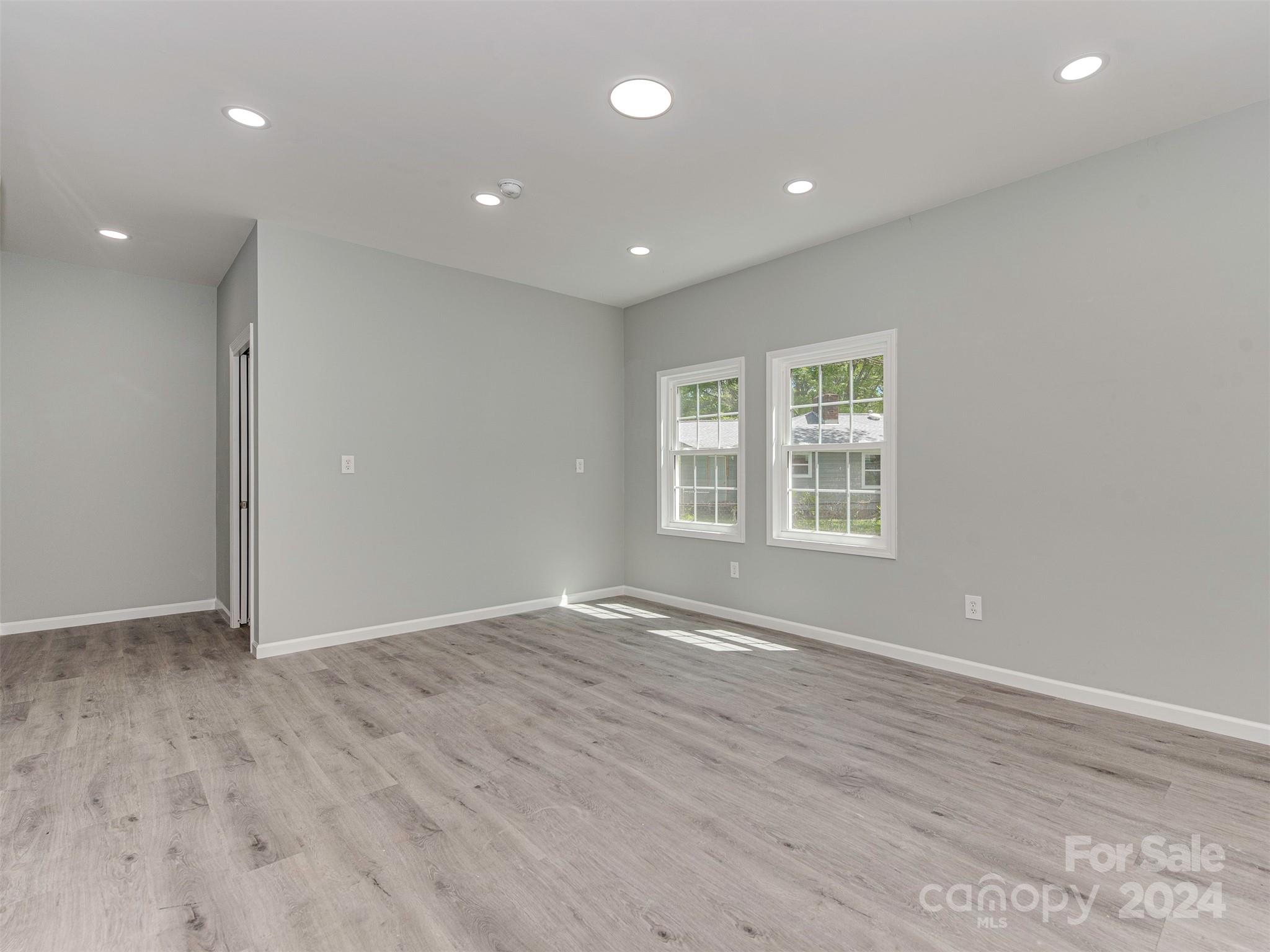 5541 Toano Road Charlotte, NC 28215 - Photo 28 of 35 an empty room with wooden floor and windows