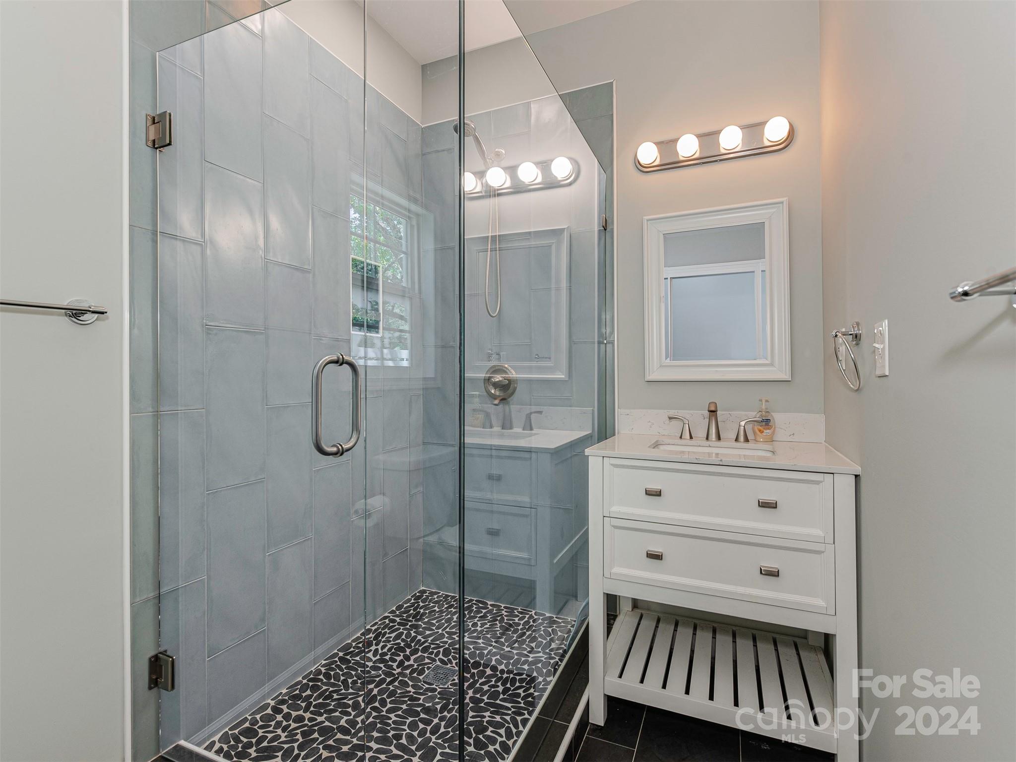 5541 Toano Road Charlotte, NC 28215 - Photo 30 of 35 a bathroom with a sink a light fixture and a mirror
