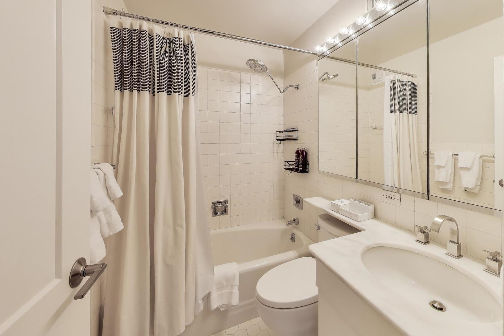 1310 North Ritchie Court, Unit 9D Chicago, IL 60610 - Photo 15 of 27 a bathroom with a sink toilet and shower