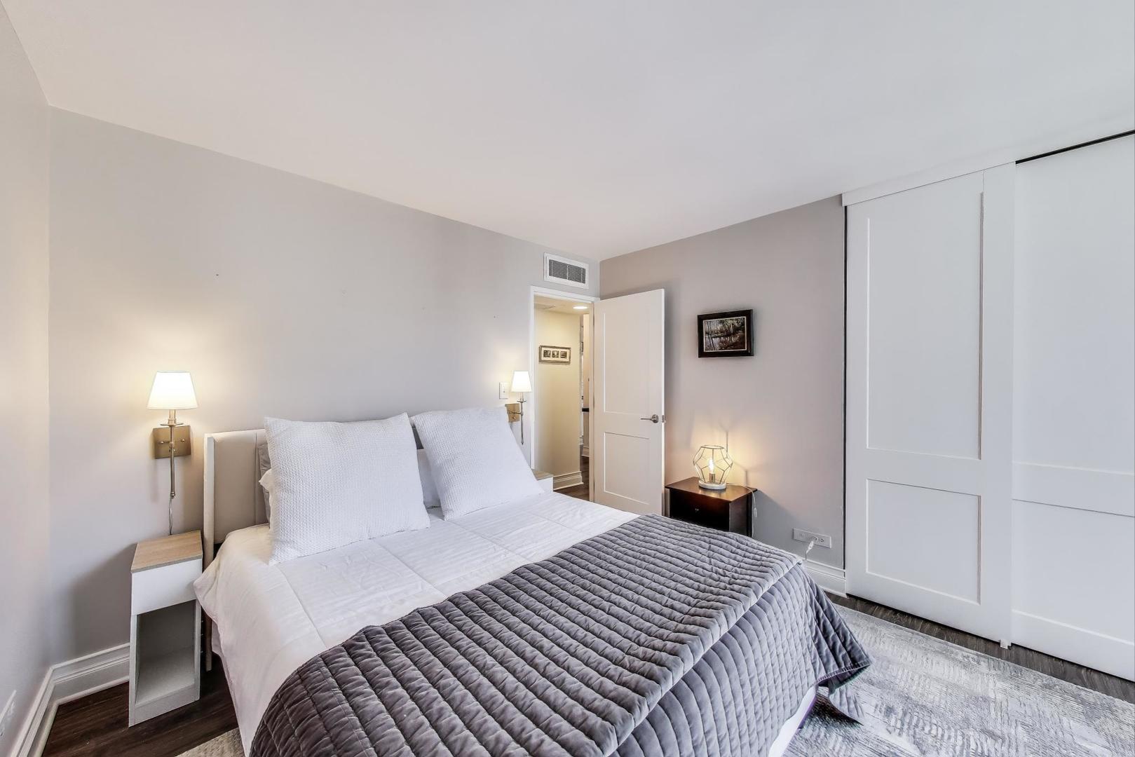 1310 North Ritchie Court, Unit 9D Chicago, IL 60610 - Photo 17 of 27 a bedroom with a bed and a lamp