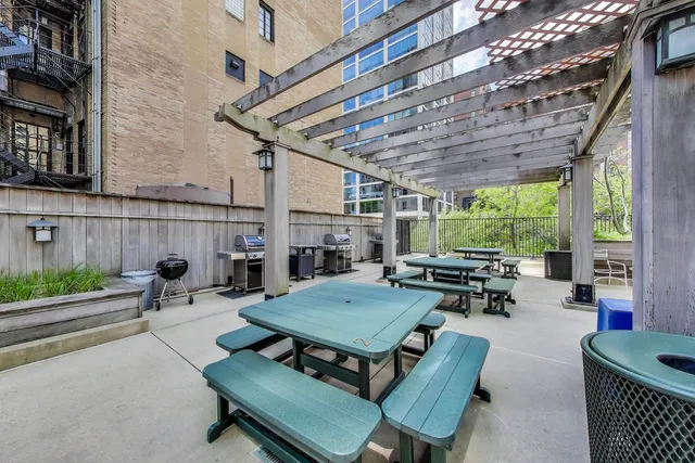 a view of a patio with chairs and a table