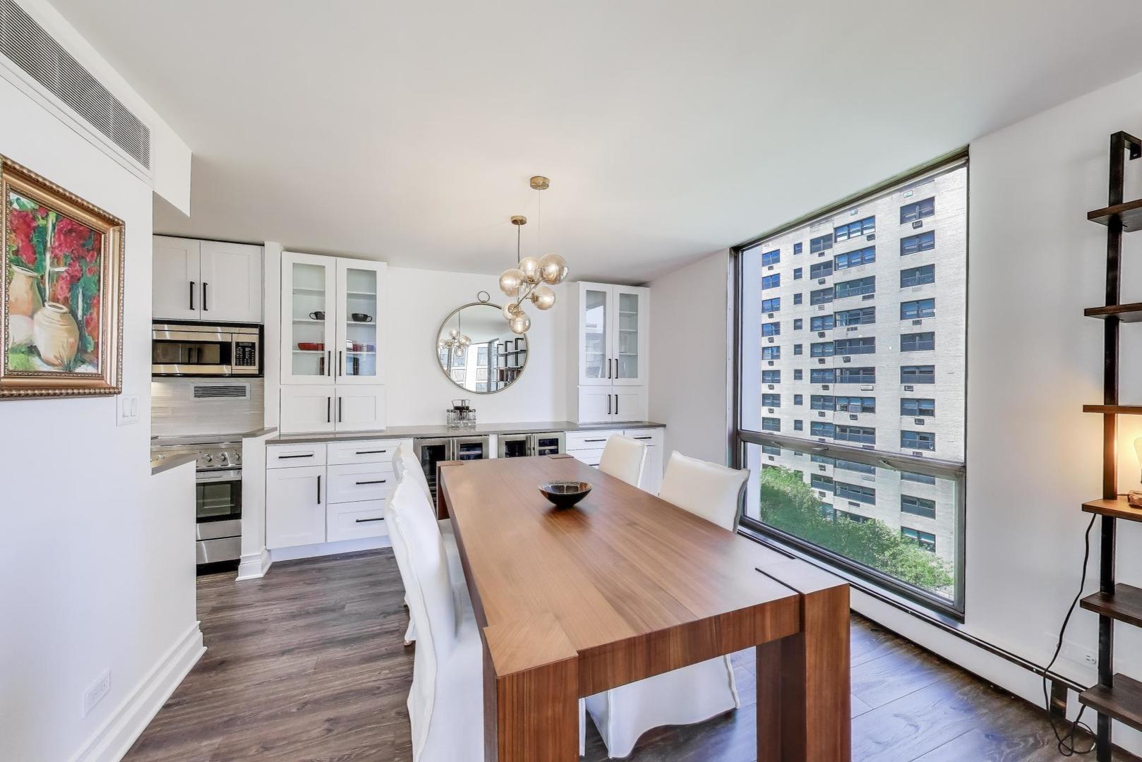 1310 North Ritchie Court, Unit 9D Chicago, IL 60610 - Photo 6 of 27 a view of a dining room and a kitchen with a table chairs