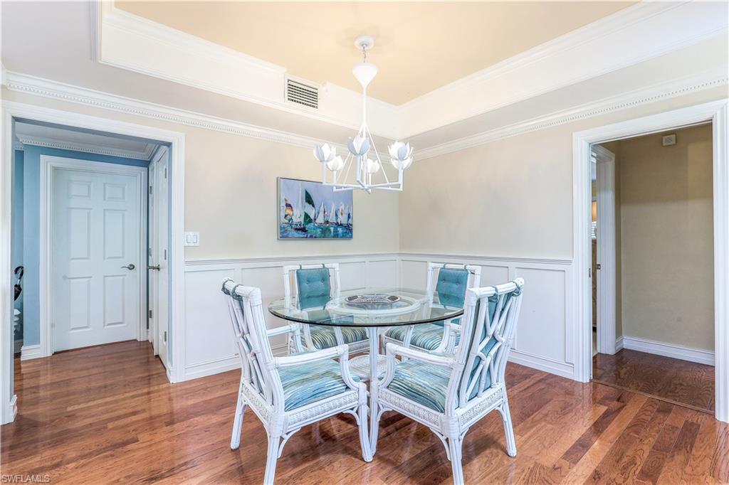 635 Anchor Rode Drive Naples, FL 34103 - Photo 19 of 50 a view of a dining room with furniture wooden floor and chandelier