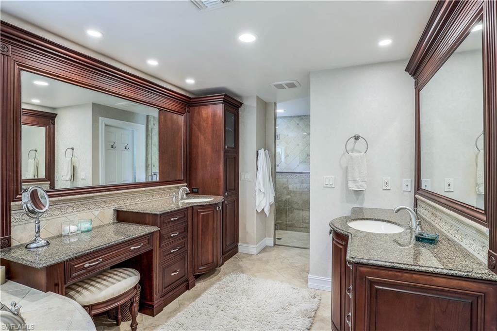 635 Anchor Rode Drive Naples, FL 34103 - Photo 26 of 50 a spacious bathroom with a granite countertop sink a mirror and a shower