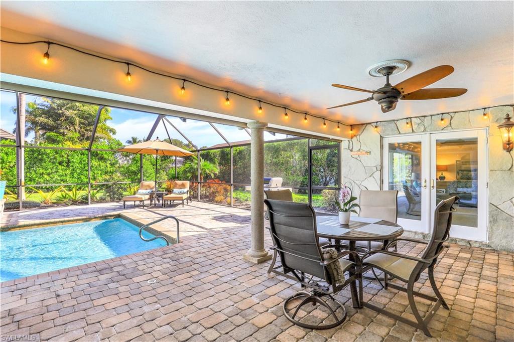 635 Anchor Rode Drive Naples, FL 34103 - Photo 36 of 50 a dining room with furniture water view and a floor to ceiling window