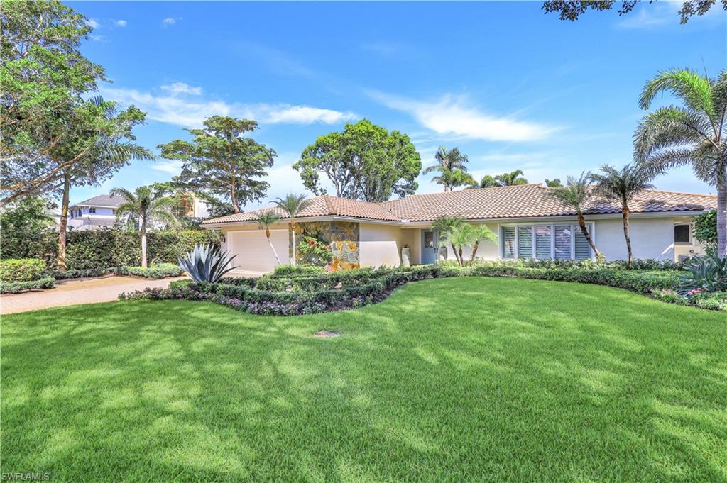 635 Anchor Rode Drive Naples, FL 34103 - Photo 4 of 50 a front view of a house with a yard and porch