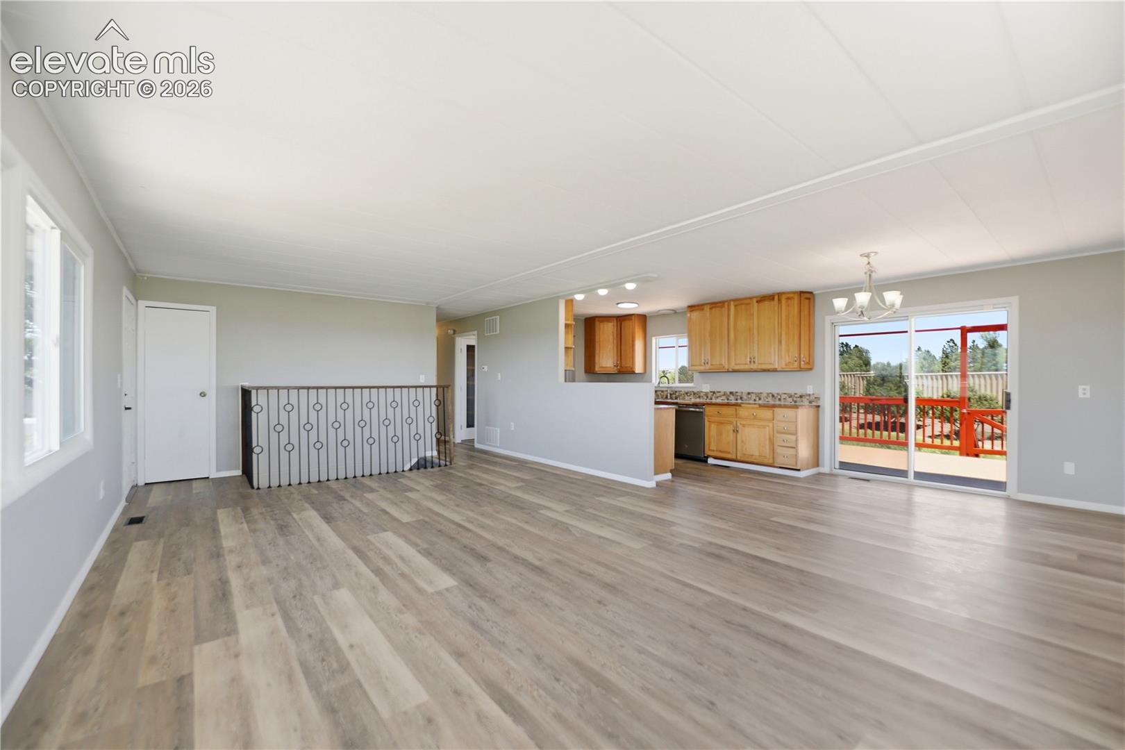 19027 Murphy Road Peyton, CO 80831 - Photo 3 of 49 Vinyl Plank, Fireplace, Open Concept Living Room, Dining Kitchen, Stairs