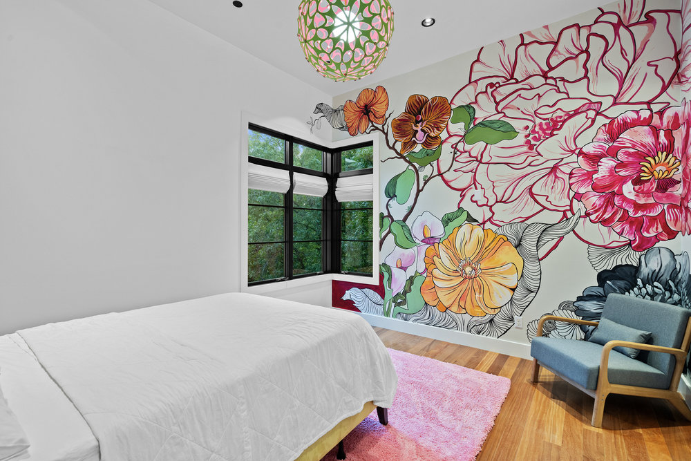 1905 Paisano Road Austin, TX 78746 - Photo 25 of 40 Artistic wall mural and rich hardwood floors create a vibrant and inviting atmosphere.