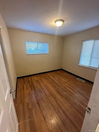a view of a livingroom with wooden floor and stairs
