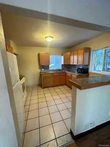 a kitchen with a sink and a stove top oven
