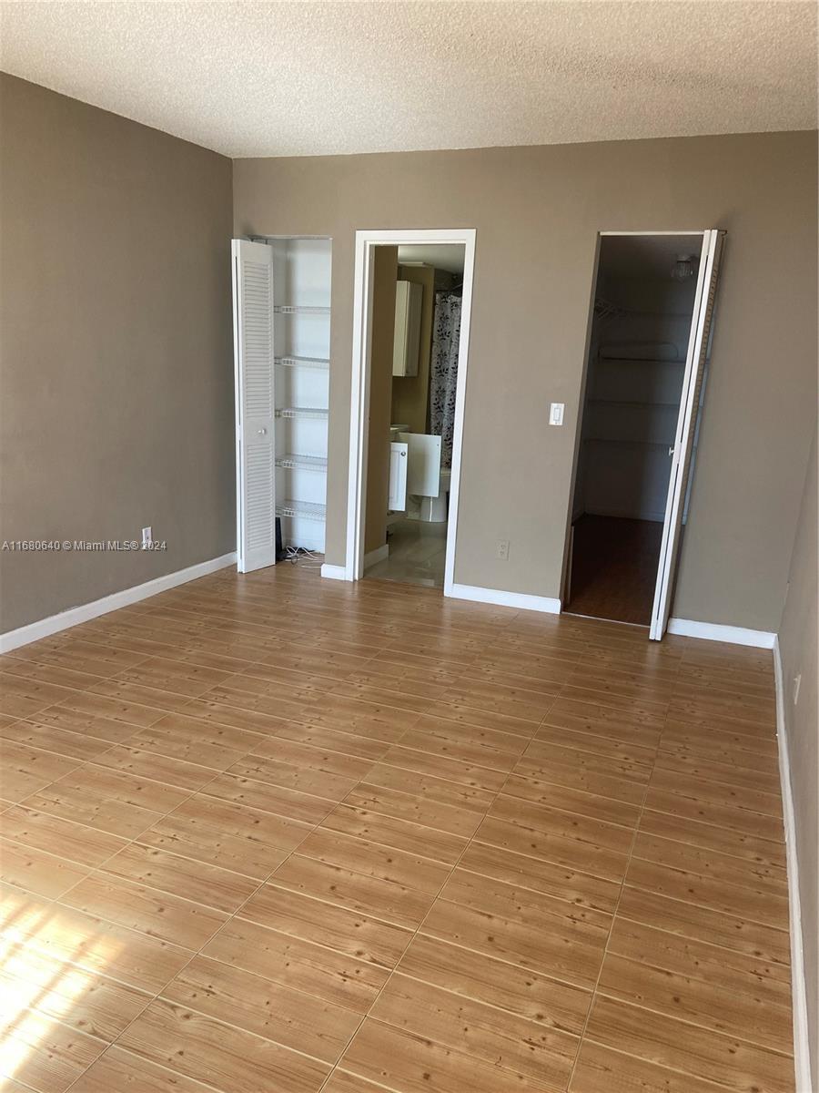 13499 Biscayne Boulevard, Unit 1506 North Miami, FL 33181 - Photo 2 of 11 a view of an empty room with wooden floor